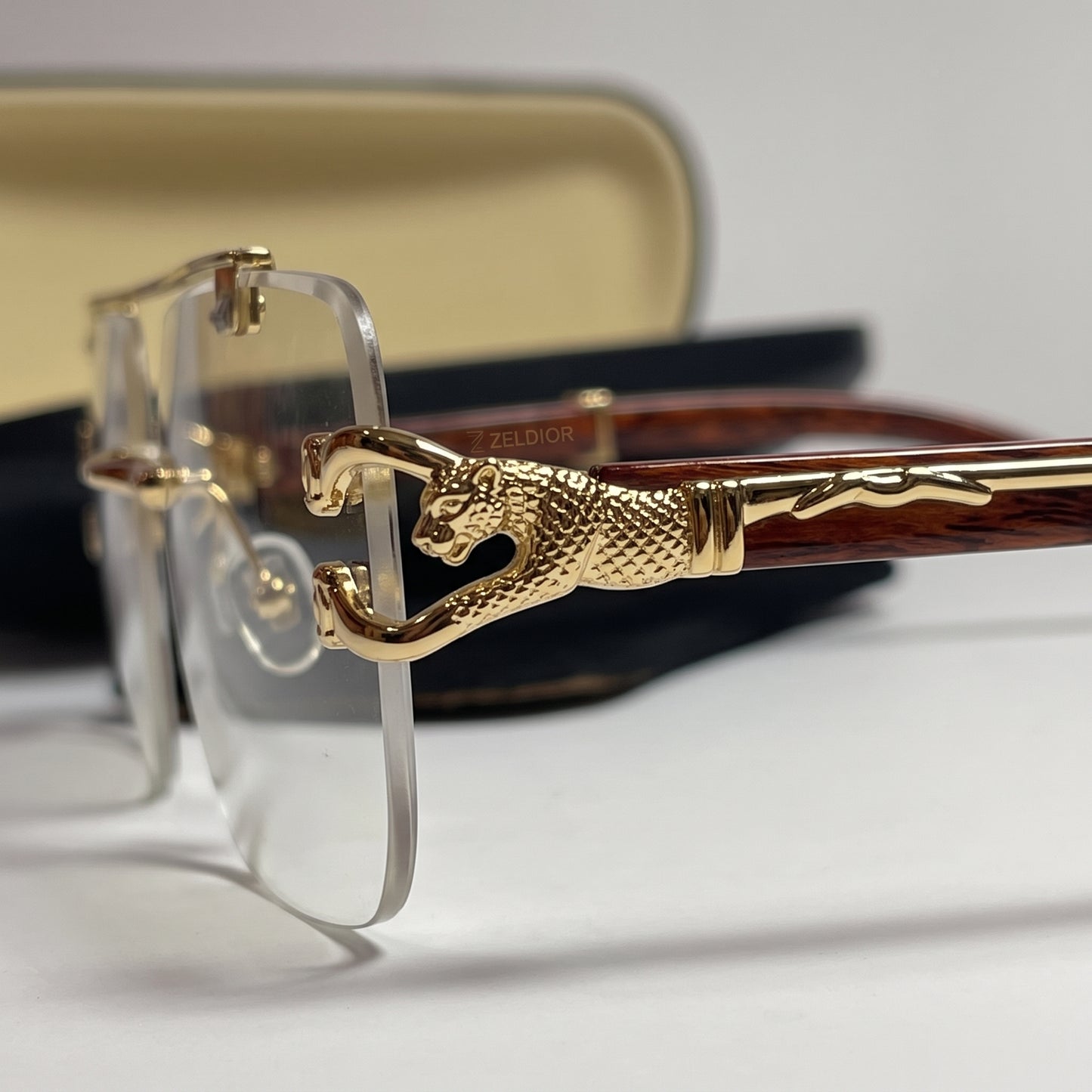 ZELDIOR rimless glasses with tortoise temples beside branded logo card and case
