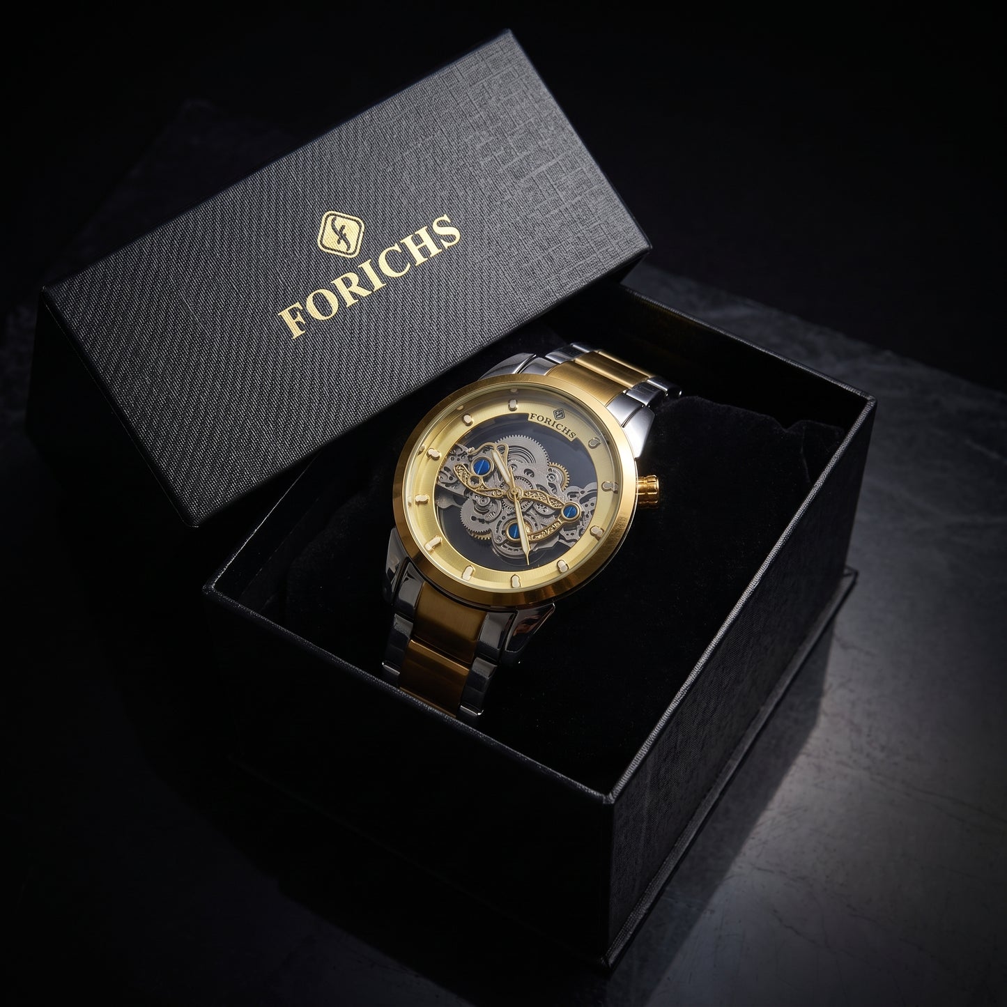 FORICHS two-tone gold automatic skeleton watch with transparent dial and gold bezel, front view
forichs-two-tone-skeleton-watch-07-box.