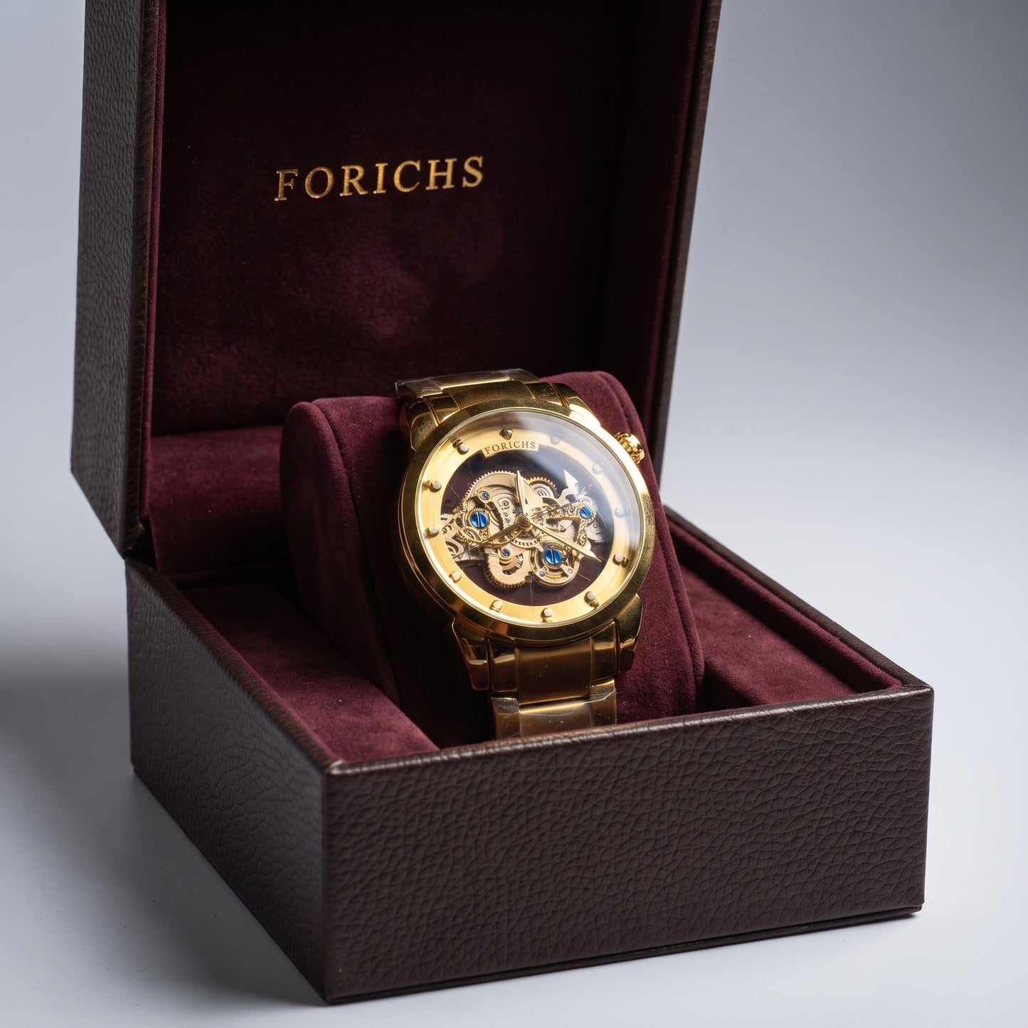 FORICHS full gold automatic skeleton watch displayed in its branded luxury presentation box