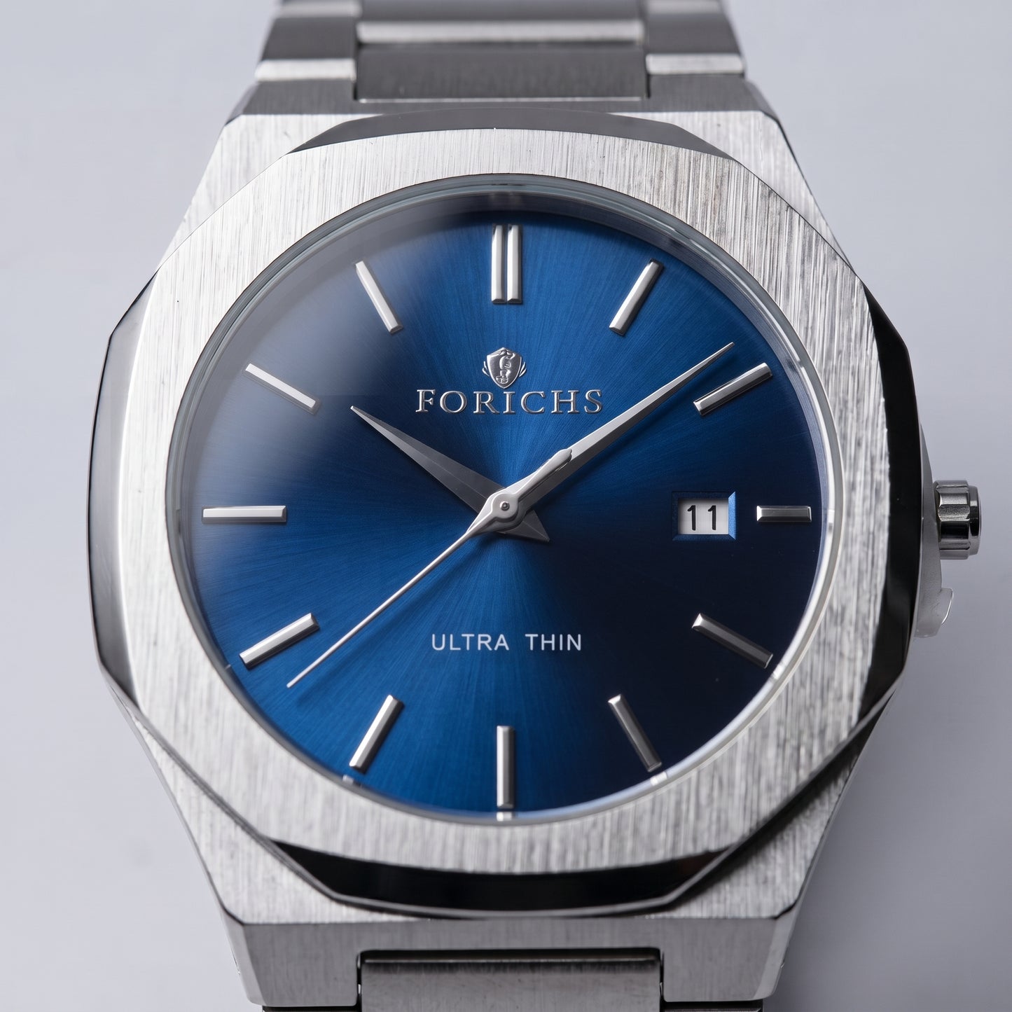 Zeldior FORICHS blue dial steel watch resting beside premium red gift box